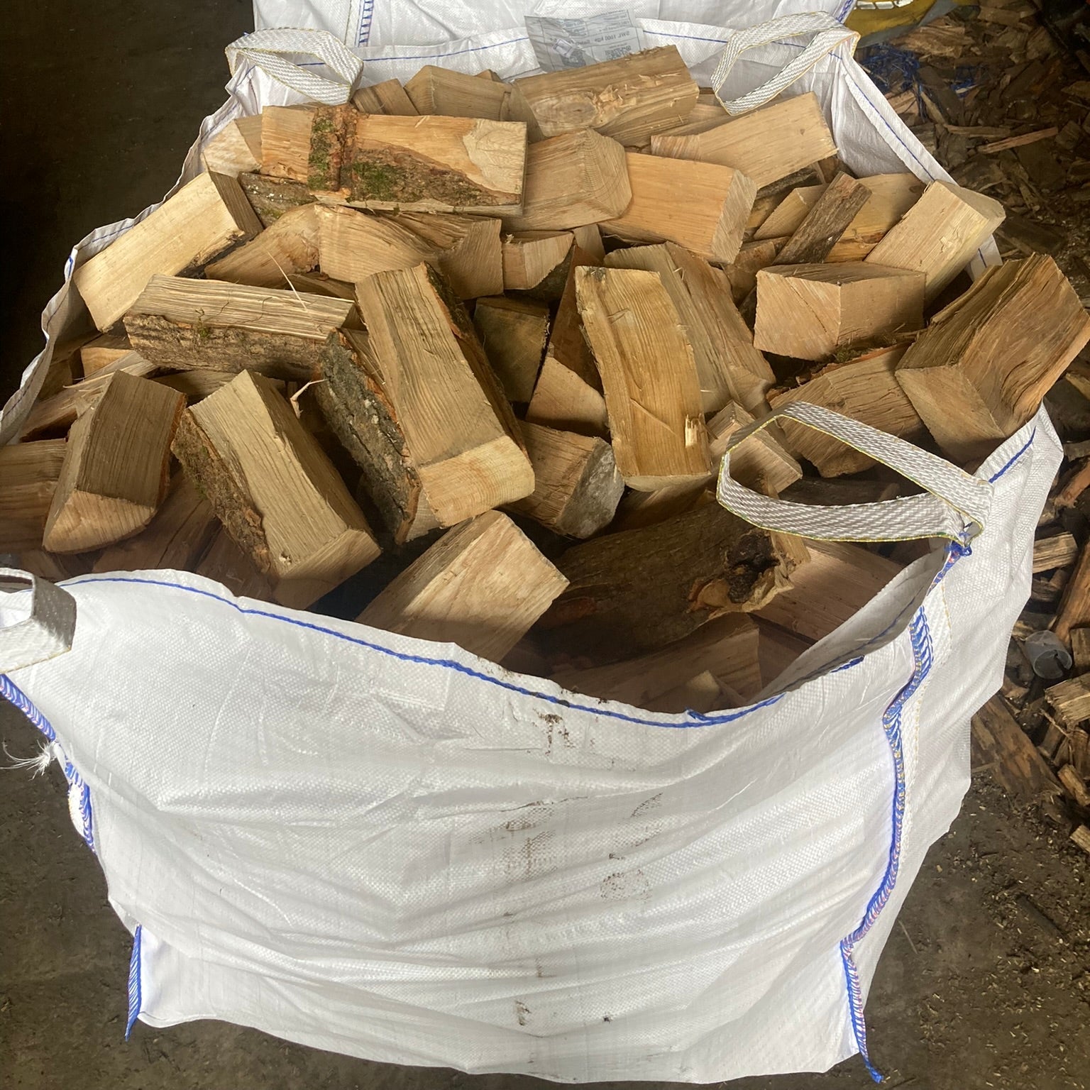 Bag of kiln dried firewood on a dark ground
