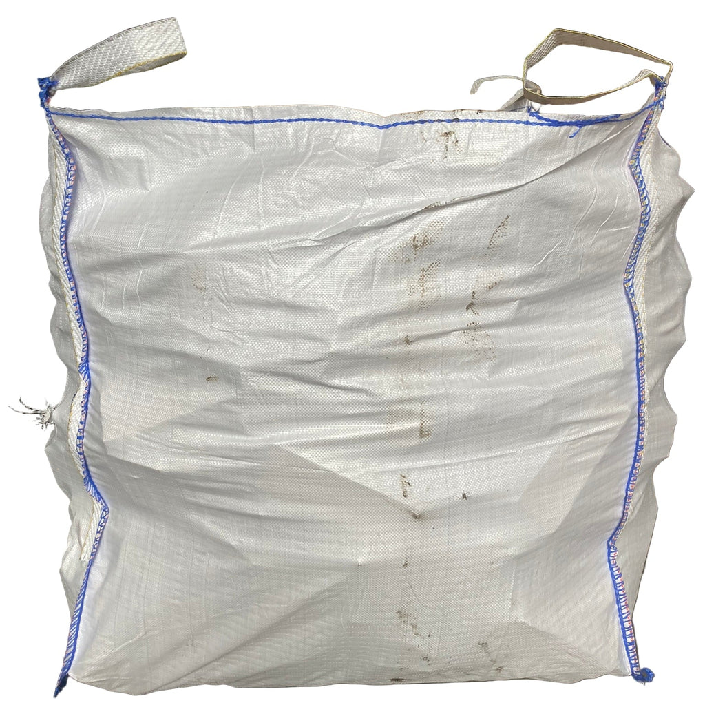 White bulk bag with blue stitching on a white background full of logs kild dried hardwood firewood